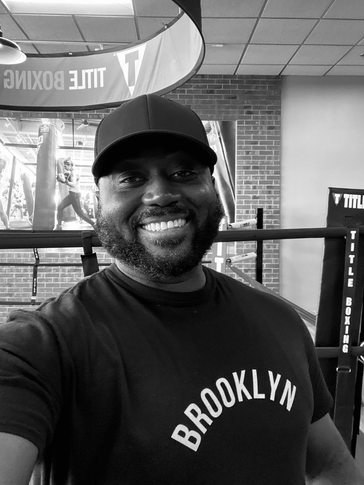 Coach Sean Archer smiling inside a boxing gym